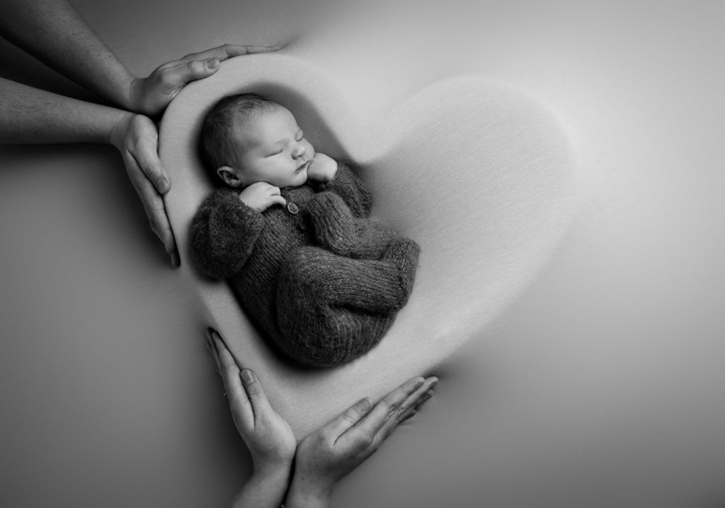 Newborn baby in heart bowl at baby photoshoot Lancashire