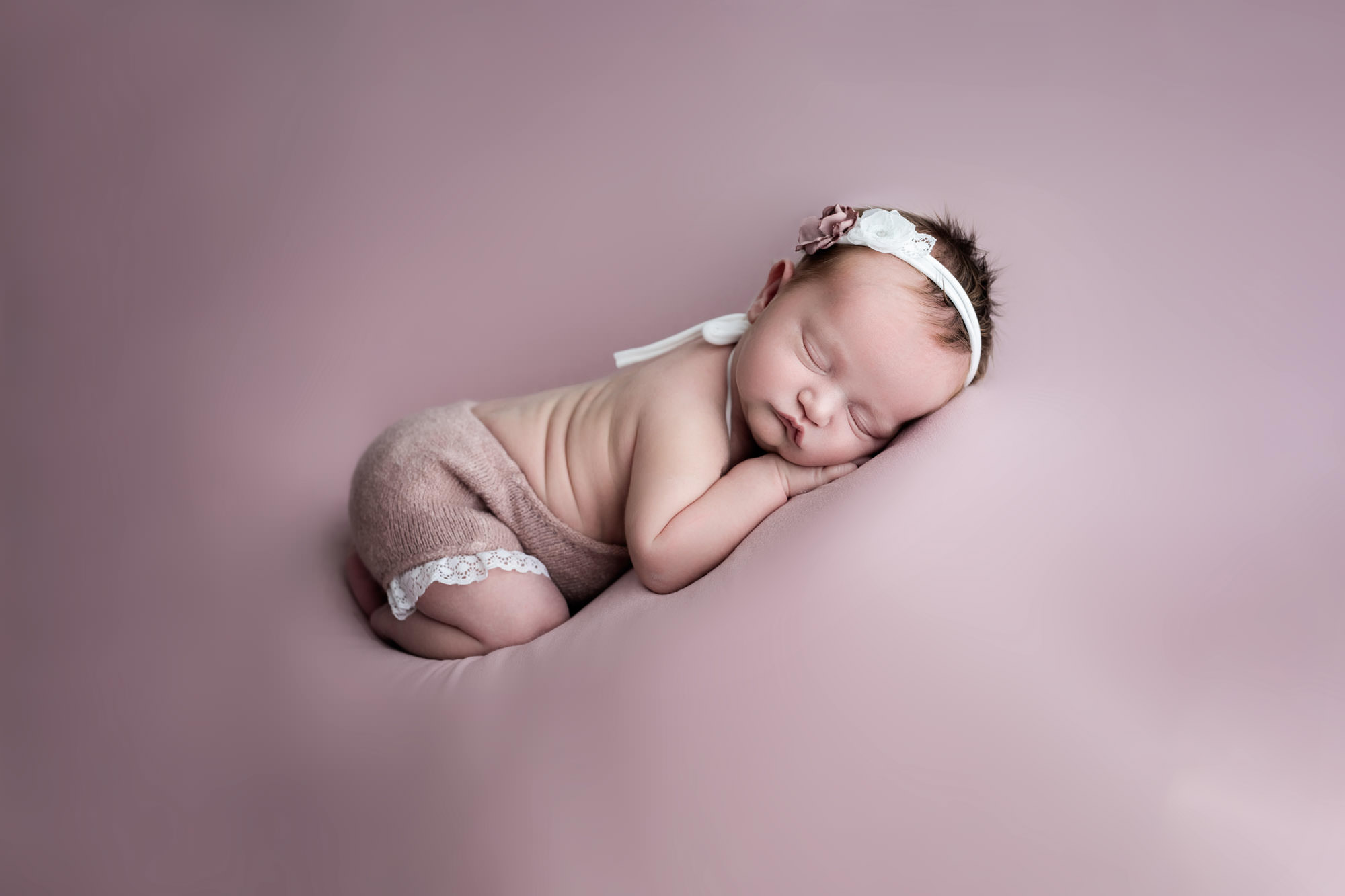 Newborn baby girl at her baby photoshoot